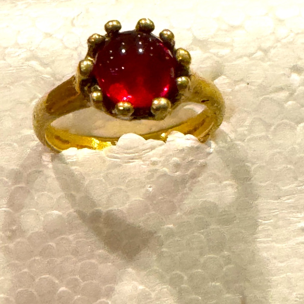 Beautiful ring with ruby-like gemstone.